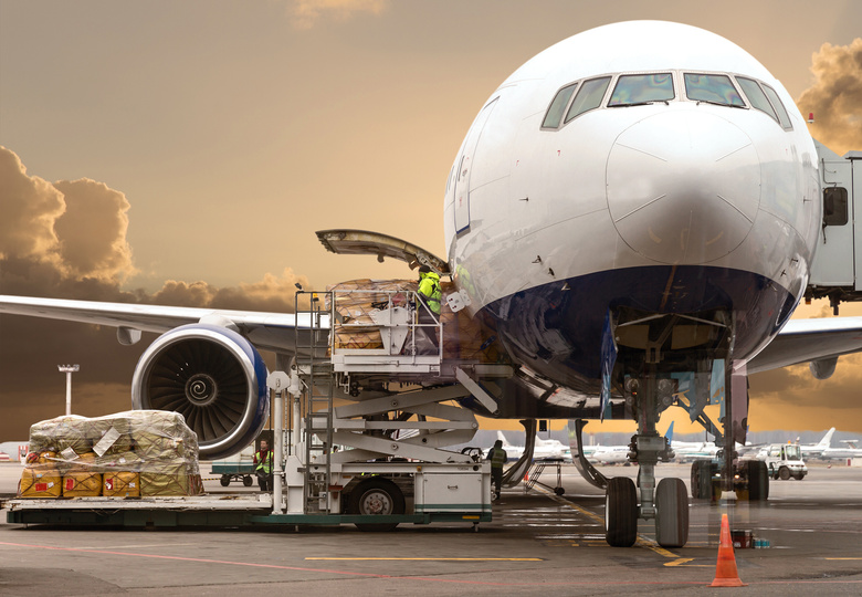 Loading Cargo into the Airplane before Departure with Nice Sky