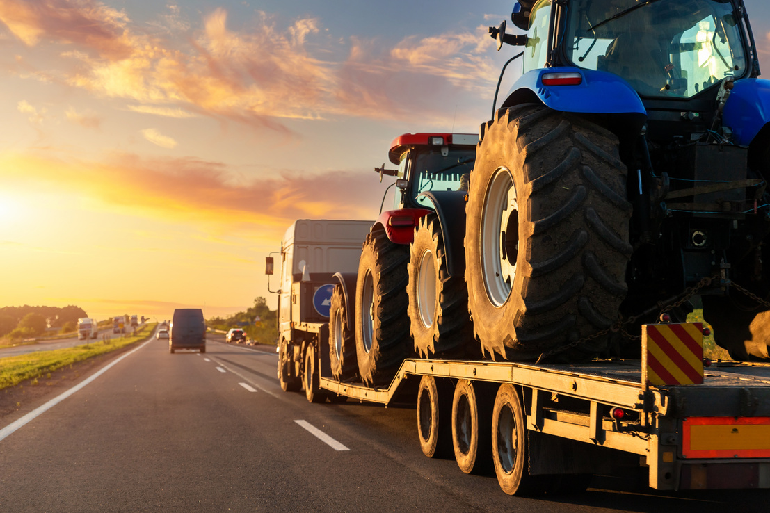 Heavy Industrial Truck Transporting Two Farm Tractors